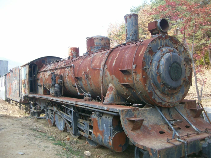 an old rusted train sitting on the tracks